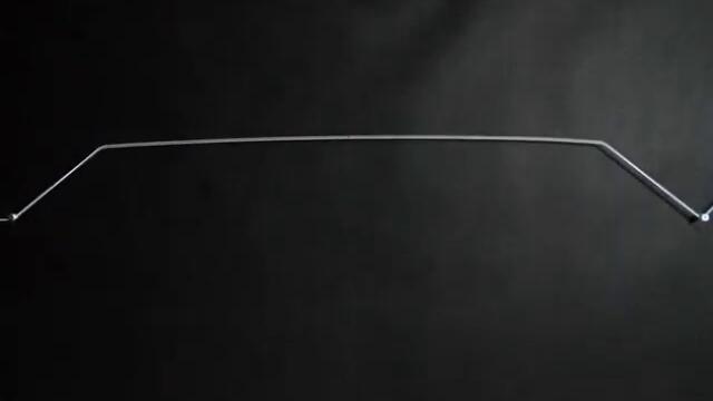 Slow motion: rubber string pulled and released